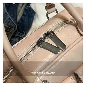 Macro detail of high-quality double-way metal zipper on pink leather bowling bag