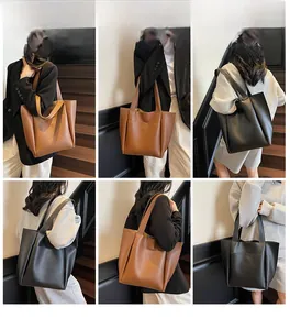 Detail view of large matte leather tote bags in black and brown on models