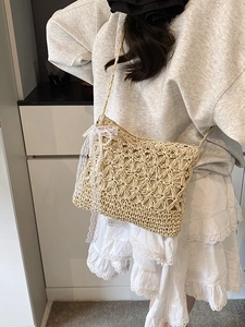 Beige star-weave straw crossbody bag with white lace bow and pearls on a model