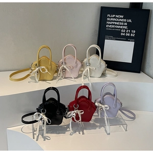 Star-shaped mini handbags in six vibrant colors with ribbon bows and pearl charms