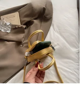 Detailed interior of a yellow mini star bag showing space for a phone and lipstick