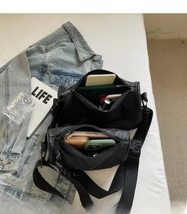 Internal structure of black cargo crossbody bag showing large capacity for daily items