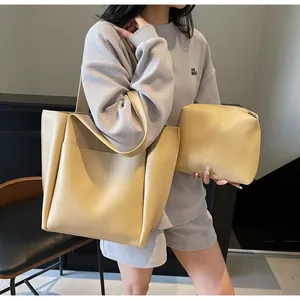 Detail view of beige PU leather tote bag set including large shoulder bag and small pouch