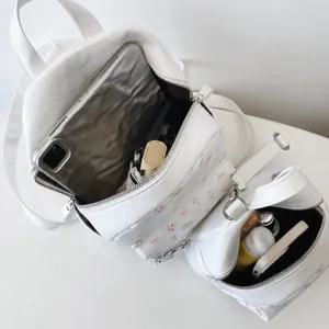 Aménagement intérieur du sac à dos matelassé blanc montrant le rangement tablette