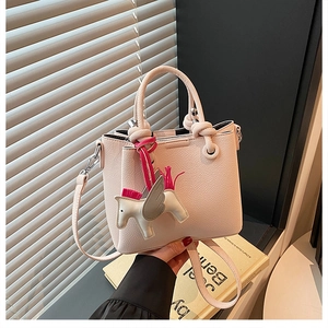 Close-up of pink lychee textured bucket bag with a cute white pegasus charm