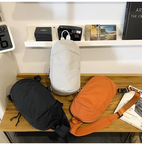 Outdoor leisure crossbody bags in black, beige, and orange with waterproof nylon texture