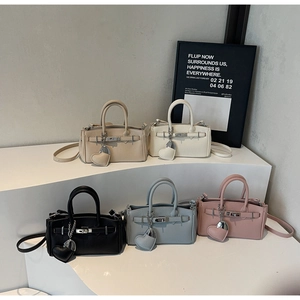 Detailed collection of five luxury textured handbags in beige, white, black, blue, and pink