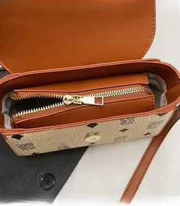 Detail of vintage square bag showing gold zipper hardware and smooth inner lining