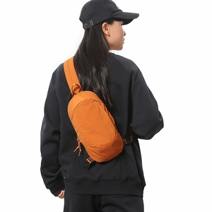 Outdoor waterproof orange crossbody bag shown on model for a casual travel style