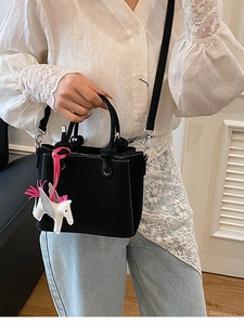Chic black matte leather bucket bag with a white horse charm decoration for women