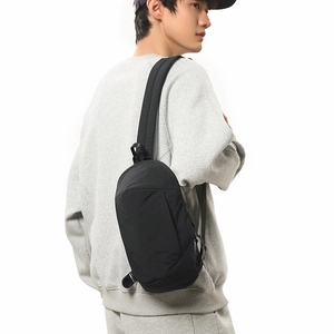 Close-up of lightweight black water-resistant crossbody bag on model for casual outdoor use
