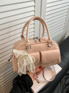 Chic light pink Boston handbag with pearl lace bow charm and adjustable shoulder strap