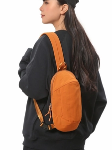 Waterproof orange crossbody bag for outdoor travel with adjustable shoulder strap