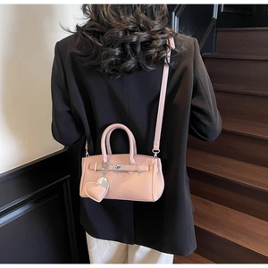 Pink lychee grain leather crossbody bag with silver hardware and heart charm detail