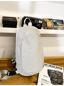 Lightweight water-resistant crossbody chest bag in light grey for outdoor travel and sports