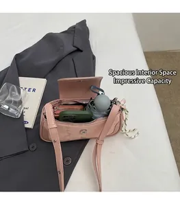 Pink embossed underarm bag showing spacious interior for phone, wallet and folding umbrella