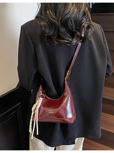 Vintage burgundy glossy crescent shoulder bag with tassel charm and gold logo