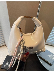 Retro cream white dumpling bag with top handle and gold clasp for a minimalist chic look