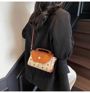 Detailed view of vintage monogram shoulder bag with gold clasp and adjustable strap