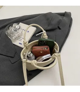 Interior view showing the spacious capacity of this off-white leather bucket handbag