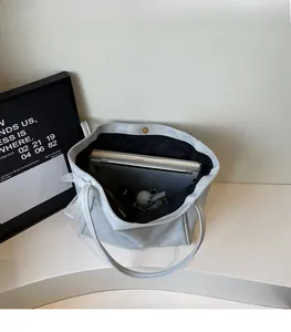 Top view of large tote bag with lace handles showing spacious interior for laptop and books