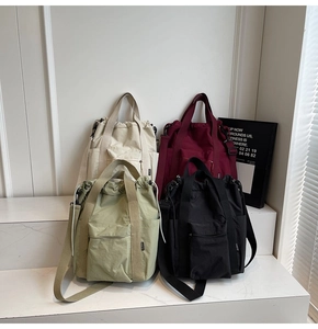 Detail showing various colors of nylon drawstring backpacks with side pockets