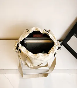 Top view of spacious canvas tote bag interior holding a laptop and multiple thick books
