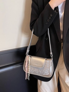Minimalist silver metallic shoulder bag with snakeskin texture and woven charms for women