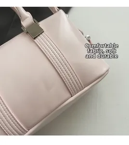 Detailed view of pink handbag showing soft leather texture and silver buckle hardware