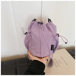 Detail of purple nylon bucket bag with drawstring closure and side mesh pocket