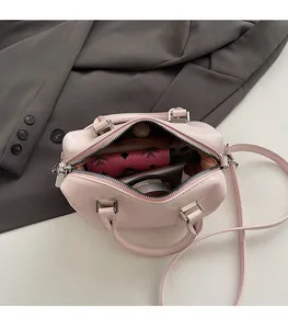 Spacious interior of the pink leather bowling bag showing ample room for essentials