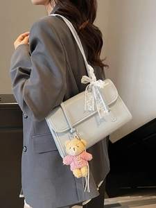 Grey minimalist leather shoulder bag with lace bow and cute teddy bear charm accessory