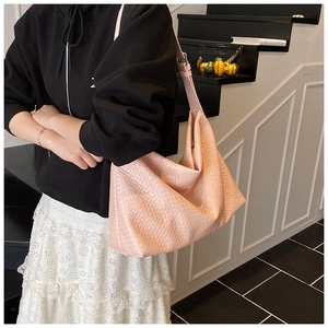 Close-up of pink woven texture on large capacity tote bag with adjustable strap