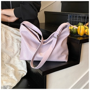 Close-up of lavender woven shoulder bag showing refined texture and adjustable strap detail