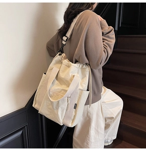 Detail of canvas tote bag showing drawstring closure, large capacity and adjustable strap