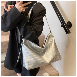 Detail of silver woven texture and metallic finish on a large commuter hobo shoulder bag
