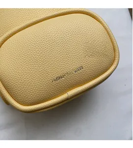 Detail of light yellow lychee grain leather mini backpack with Fashion & Bags logo
