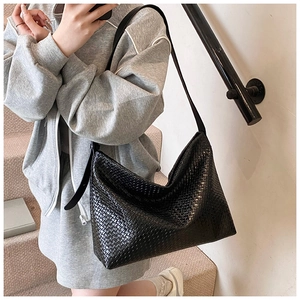Detailed view of black woven texture leather hobo bag with adjustable slim strap