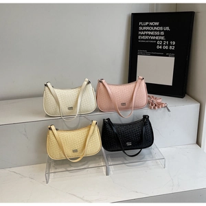 Detail of woven texture crescent bags in four colors with adjustable shoulder straps