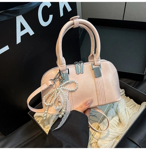Rosafarbene Handtasche aus mattem Leder mit Perlen-Schleifen-Anhänger und Spitze