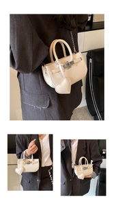 Detail of cream white mini handbag featuring glossy faux leather and heart charm detail