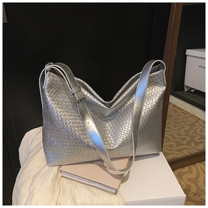 Detail of silver woven hobo bag with metallic leather texture and adjustable strap