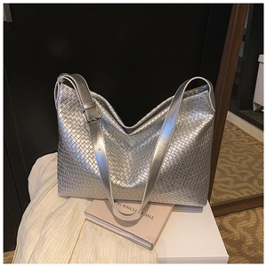 Detail showing metallic silver woven texture and adjustable shoulder strap buckle