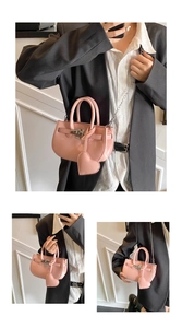 Macro view of pink patent leather handbag featuring silver twist lock and heart charm