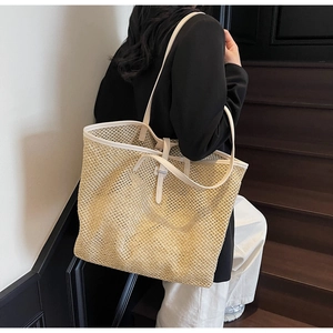 Détail du grand sac cabas en paille avec brides en cuir blanc et design tissé ajouré