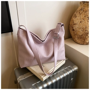Detail of purple woven leather tote bag with adjustable shoulder strap and metal buckle