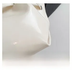 Macro detail of high-quality cream white oil wax leather with pleated texture on bucket bag