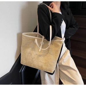 Détail du grand sac cabas en paille avec tissage ajouré et bandoulières blanches