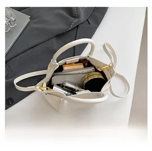 Interior view of the cream white PU shoulder bag showing daily items storage capacity