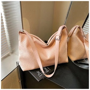 Detail of pink woven texture on large tote bag with adjustable silver buckle strap